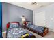 The bedroom showcases themed beds with matching pillows, closet, and a cozy atmosphere at 7184 Oakmoss Loop, Davenport, FL 33837