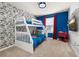 bedroom featuring bunk beds, comic wallpaper, and blue accent wall at 7184 Oakmoss Loop, Davenport, FL 33837