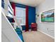 View of bunkbed bedroom featuring red accents and a wall-mounted television at 7184 Oakmoss Loop, Davenport, FL 33837
