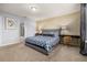 Well-lit bedroom featuring a plush bed, modern decor, a desk, and a large window at 7184 Oakmoss Loop, Davenport, FL 33837