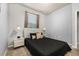 Modern bedroom with neutral decor, a dark comforter, and two nightstands at 7184 Oakmoss Loop, Davenport, FL 33837