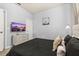 Modern bedroom with neutral decor, a dark comforter, and dresser with television at 7184 Oakmoss Loop, Davenport, FL 33837