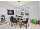 Bright dining room with a modern glass table and contemporary chandelier at 7184 Oakmoss Loop, Davenport, FL 33837