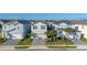 Two-story home featuring a well-maintained lawn and a two-car garage on a sunny day at 7184 Oakmoss Loop, Davenport, FL 33837