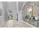Bright foyer with tile flooring and a view of the front yard, with a decorative mirror and table at 7184 Oakmoss Loop, Davenport, FL 33837