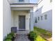 The front door with a small porch provides a welcoming entrance to the home at 7184 Oakmoss Loop, Davenport, FL 33837