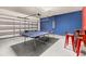 The garage is set up for entertainment with ping pong and a cozy hangout space at 7184 Oakmoss Loop, Davenport, FL 33837