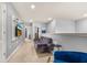 Spacious upstairs hallway with a gray couch and a blue chair at 7184 Oakmoss Loop, Davenport, FL 33837