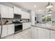 Kitchen featuring stainless steel appliances, granite countertops, and ample cabinet space at 7184 Oakmoss Loop, Davenport, FL 33837