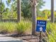 Solterra Resort sign points to a lazy river amenity surrounded by green shrubbery and palm trees at 7184 Oakmoss Loop, Davenport, FL 33837