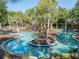 A scenic lazy river with island feature and lush landscaping offers a tranquil escape for residents at 7184 Oakmoss Loop, Davenport, FL 33837