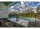 This is an outdoor patio with a dining table set by the pool, great for entertaining at 7184 Oakmoss Loop, Davenport, FL 33837