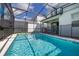 Stunning screened-in pool offering a refreshing escape in a private backyard oasis at 7184 Oakmoss Loop, Davenport, FL 33837