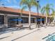Outdoor poolside dining area with ample seating and bar near a community pool at 7184 Oakmoss Loop, Davenport, FL 33837