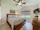 Comfortable bedroom with a large window, ceiling fan, and natural light at 8019 Indian Creek Blvd, Kissimmee, FL 34747