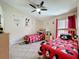 Charming bedroom with two twin beds, ceiling fan and fun Mickey Mouse themed decor throughout at 8019 Indian Creek Blvd, Kissimmee, FL 34747