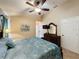 Bedroom with a ceiling fan, a dark wood furniture set and neutral colored walls at 8019 Indian Creek Blvd, Kissimmee, FL 34747