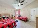 Bedroom featuring twin beds with Mickey Mouse decor, ceiling fan, and neutral paint at 8019 Indian Creek Blvd, Kissimmee, FL 34747