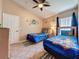 Bedroom with twin beds, ceiling fan, Scooby Doo decor, and natural light at 8019 Indian Creek Blvd, Kissimmee, FL 34747