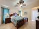 Inviting bedroom featuring a ceiling fan, stylish furniture, and warm, inviting lighting at 8019 Indian Creek Blvd, Kissimmee, FL 34747