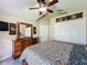 Comfortable bedroom with a dresser, closet, and ceiling fan at 8019 Indian Creek Blvd, Kissimmee, FL 34747