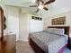Well-lit bedroom featuring a ceiling fan, closet space, and a cozy atmosphere at 8019 Indian Creek Blvd, Kissimmee, FL 34747