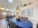 Open dining space featuring a blue table, stylish decor, and a view of the kitchen at 8019 Indian Creek Blvd, Kissimmee, FL 34747
