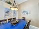 Close-up of dining area featuring blue table with unique decor and stylish lighting at 8019 Indian Creek Blvd, Kissimmee, FL 34747