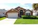 Charming single-Gathering home with attached garage, lush lawn, and well-maintained landscaping at 8019 Indian Creek Blvd, Kissimmee, FL 34747
