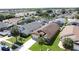 Aerial view showcasing a well-kept home with a lush front lawn, palm trees, and a long driveway at 8019 Indian Creek Blvd, Kissimmee, FL 34747