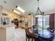 Open kitchen and dining area with stainless steel appliances and a round glass table with seating at 8019 Indian Creek Blvd, Kissimmee, FL 34747