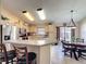 Eat-in kitchen featuring stainless steel appliances, light wood cabinets, and a breakfast bar with seating at 8019 Indian Creek Blvd, Kissimmee, FL 34747