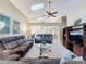 Spacious living room featuring vaulted ceilings, skylights, tile flooring, and comfortable seating at 8019 Indian Creek Blvd, Kissimmee, FL 34747
