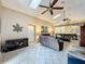 Open living space with high ceilings, tile floors, comfortable sofas, and access to dining area at 8019 Indian Creek Blvd, Kissimmee, FL 34747