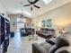 Living area with high ceilings, ceiling fans, tile flooring, comfortable sofas, and sliding door at 8019 Indian Creek Blvd, Kissimmee, FL 34747