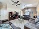Inviting living space with high ceilings, ceiling fans, tile flooring, comfortable sofas, and doorway at 8019 Indian Creek Blvd, Kissimmee, FL 34747