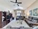 Open-concept living area featuring tile floors, ceiling fans, comfortable seating, and natural light at 8019 Indian Creek Blvd, Kissimmee, FL 34747
