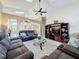Bright and airy living area with vaulted ceiling, tile floors, comfortable sofas, and entertainment center at 8019 Indian Creek Blvd, Kissimmee, FL 34747