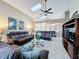 Comfortable living room area with high ceilings, tile floors, large sofas, and access to dining room at 8019 Indian Creek Blvd, Kissimmee, FL 34747