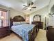 This is a bedroom with dark wood furniture and a ceiling fan at 8019 Indian Creek Blvd, Kissimmee, FL 34747