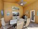 Covered patio featuring outdoor dining table, grill, and decorated exterior door at 8019 Indian Creek Blvd, Kissimmee, FL 34747