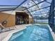 Backyard pool features a screened lanai, spa, and comfortable seating at 8019 Indian Creek Blvd, Kissimmee, FL 34747