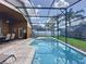 Enclosed pool and patio area with comfortable seating and an outdoor dining space at 8019 Indian Creek Blvd, Kissimmee, FL 34747