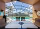 Back patio overlooking screened in pool area and backyard at 8019 Indian Creek Blvd, Kissimmee, FL 34747