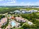 Aerial view of condos with large pool, surrounded by lush greenery and other community amenities at 8601 Worldquest Blvd # B1/U3502, Orlando, FL 32821