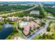 Aerial view of condos with a large pool, mature landscaping, parking, and proximity to major roads at 8601 Worldquest Blvd # B1/U3502, Orlando, FL 32821