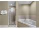 Cozy bathroom with a large corner bathtub and glass-enclosed shower at 8601 Worldquest Blvd # B1/U3502, Orlando, FL 32821