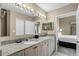 Bathroom boasting a double vanity with granite countertop and views into the bedroom at 8601 Worldquest Blvd # B1/U3502, Orlando, FL 32821