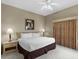 Comfortable bedroom featuring a king bed, nightstands, carpet floors and ornate curtains at 8601 Worldquest Blvd # B1/U3502, Orlando, FL 32821