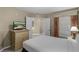 Relaxing bedroom with comfortable bed, nightstand, dresser with a TV and lots of natural light at 8601 Worldquest Blvd # B1/U3502, Orlando, FL 32821